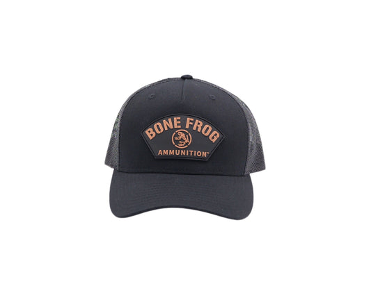 Front facing photo of Bone Frog Ammunition Snapback Trucker Hat Black with Black/Tan PVC Curve Logo sewn on